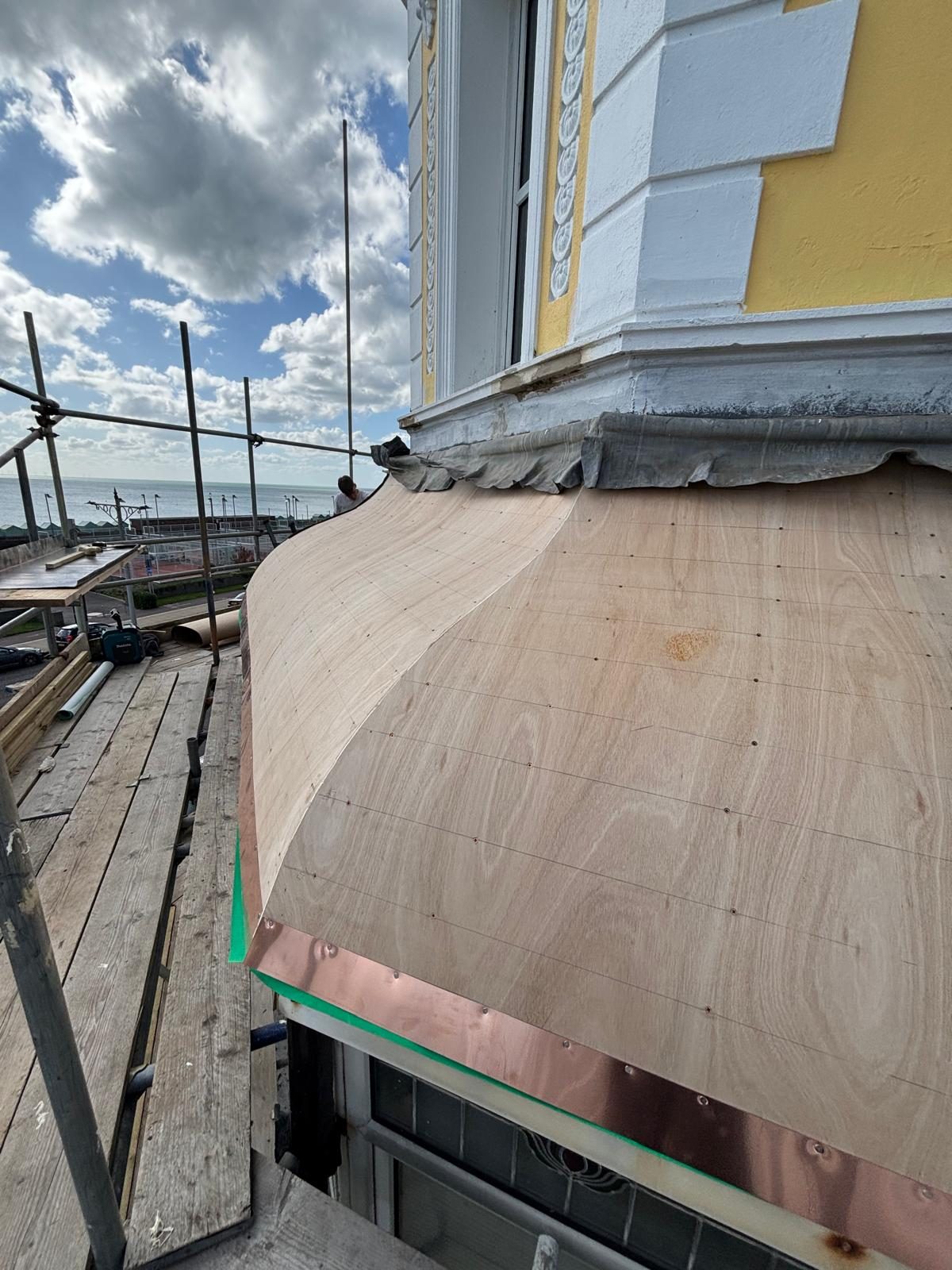 Curved dormer cheek shaped in plywood ready for lead