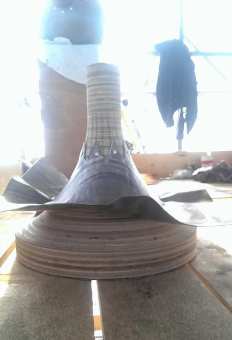 Spun lead finial base being formed